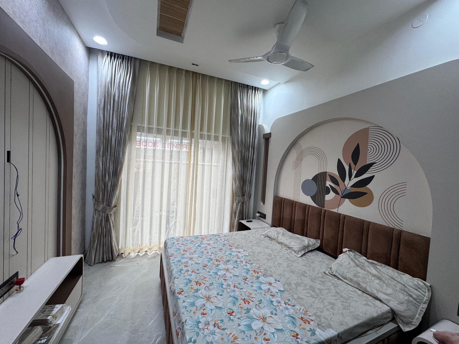 Designer wallpaper installation in a premium bedroom